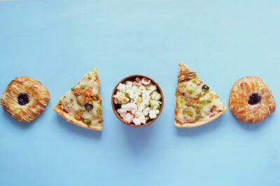 this is the image of so-called junk food like pizza and donuts - common foods in the Standard American Diet that aggravate symptoms of depression and anxiety